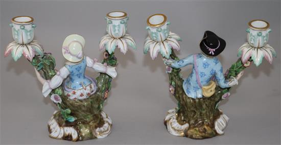 A pair of Meissen figural candelabra, late 19th century, height 19.5cm, typical minor losses to flowers, replacement nozzles